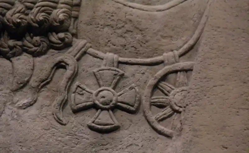 Maltese cross, and solar discs pendants on the limestone stela of Ashurnasirpal II